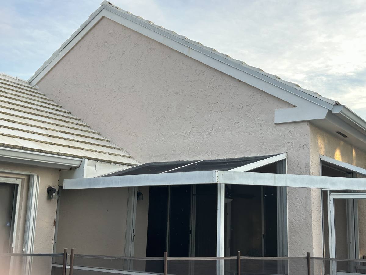 Stucco repair above screened porch after β Simon Stucco Services